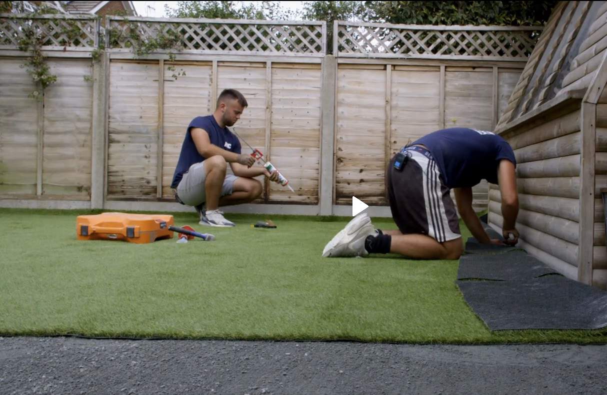 Fitting artificial grass lawn Artificial grass being fitted during installation